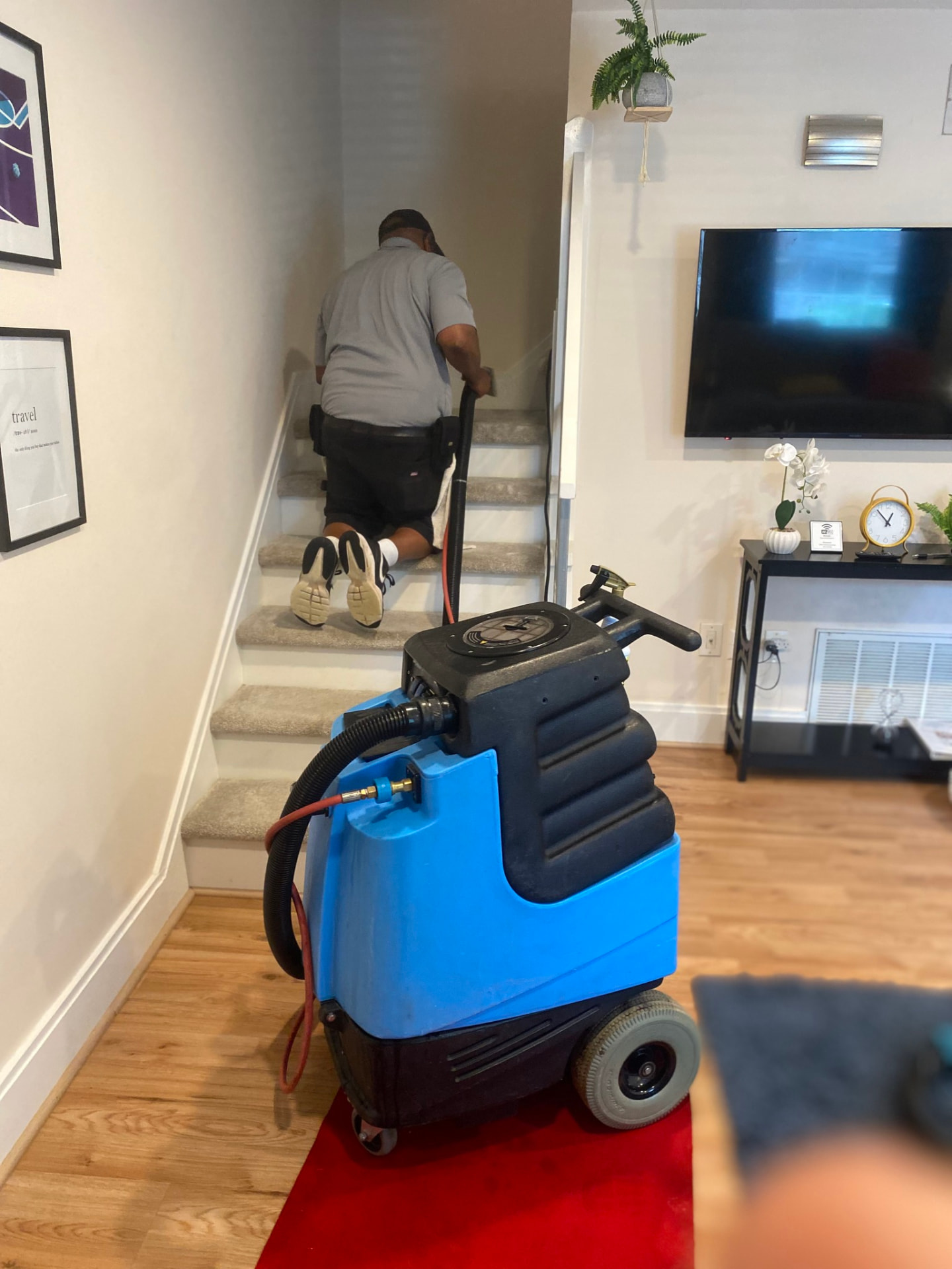 A cleaner working on carpeted stairs